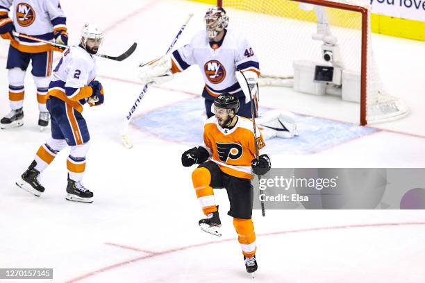 Scott Laughton of the Philadelphia Flyers celebrates after scoring the game-winning goal past Semyon Varlamov of the New York Islanders during the...
