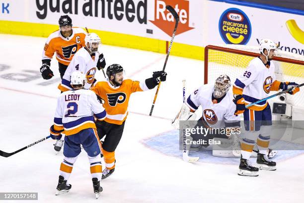 Scott Laughton of the Philadelphia Flyers celebrates after scoring the game-winning goal past Semyon Varlamov of the New York Islanders during the...