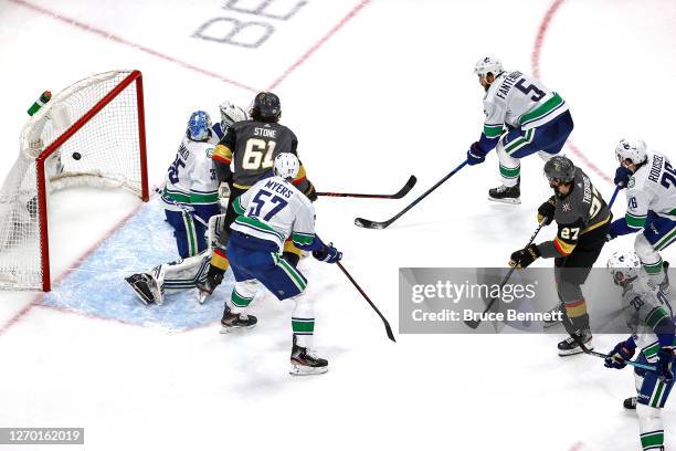 Shea Theodore of the Vegas Golden Knights scores a goal past Thatcher Demko of the Vancouver Canucks during the second period in Game Five of the...