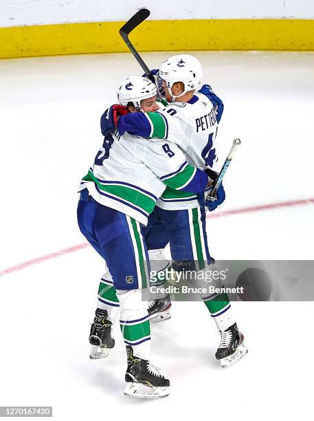 Elias Pettersson of the Vancouver Canucks is congratulated by his teammate, J.T. Miller after scoring a goal against the Vegas Golden Knights during...