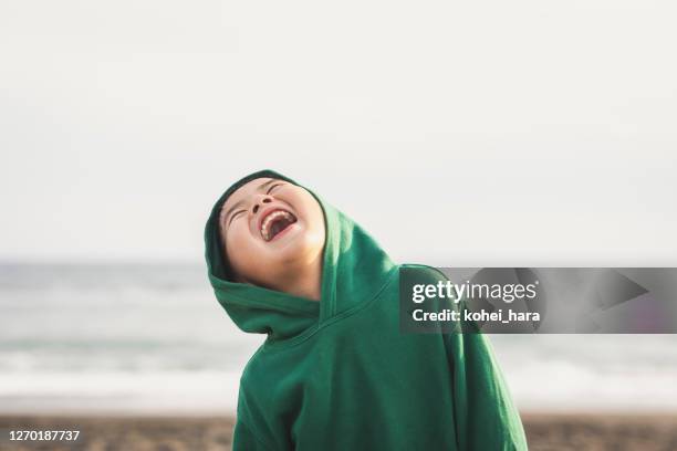 portrait of boy standing in the spring beach - child laughing imagens e fotografias de stock