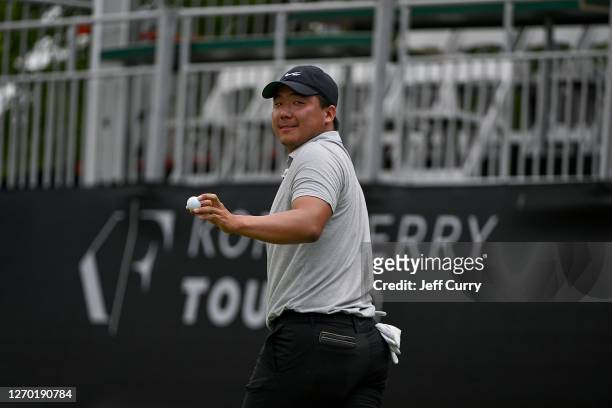 Norman Xiong waves to the gallery after sinking his putt on the 18th green during the first round of the Memorial Health Championship presented by...