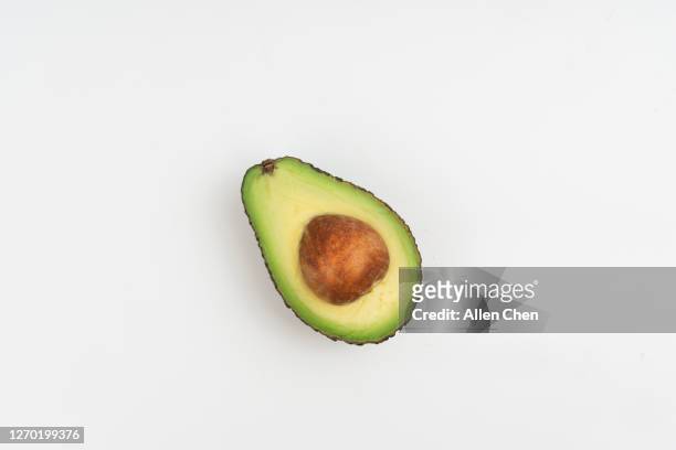 avocado on white background - avocado isolated stock-fotos und bilder