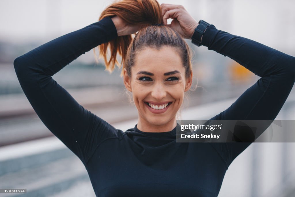 Fittnes woman tying her hair