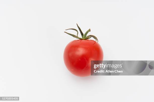 one red cherry tomatoes on white background - cherry tomato stock pictures, royalty-free photos & images