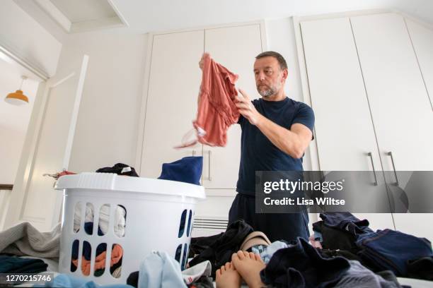 dad folding laundry - lean in collection father stock pictures, royalty-free photos & images