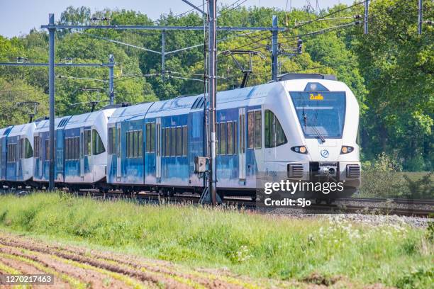 arriva commuter train driving through the vechtdal landscape - zwolle stock pictures, royalty-free photos & images