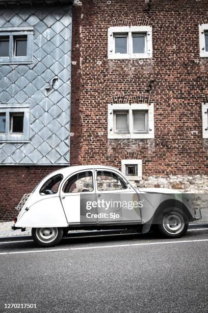 classic french citroën 2cv car parked on the side of the street - deux chevaux stock pictures, royalty-free photos & images