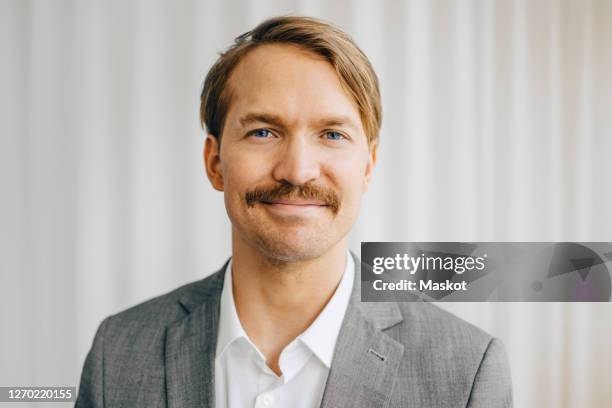 portrait of businessman standing in office - gray jacket fotografías e imágenes de stock