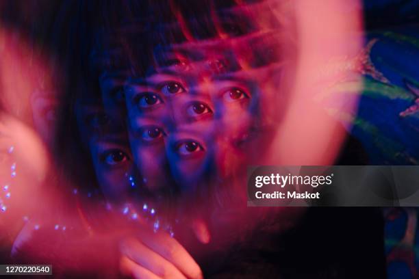 multiple exposure of woman's eye at illuminated bar - double exposure portrait stock pictures, royalty-free photos & images