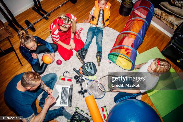 high angle view of family sitting on floor - indoor skating stock pictures, royalty-free photos & images