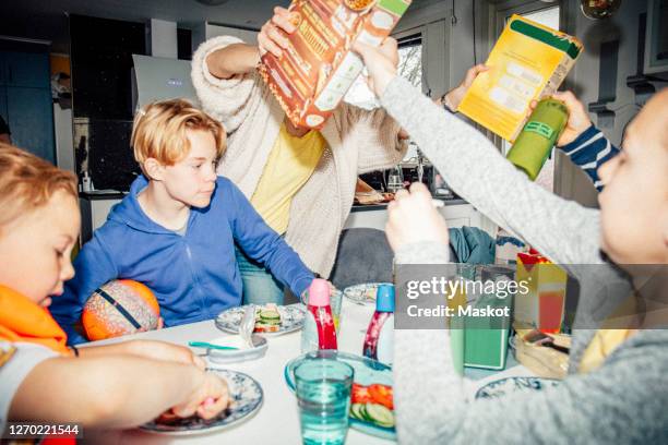 family eating breakfast at table - flash ストックフォトと画像