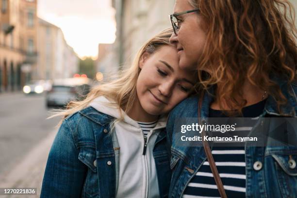 smiling mother and daughter in city - teen daughter stock pictures, royalty-free photos & images