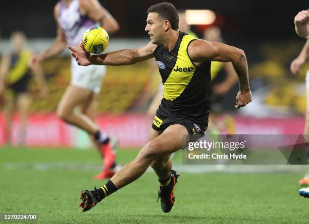 Jack Graham of the Tigers controls the ball during the round 15 AFL match between the Richmond Tigers and the Fremantle Dockers at Metricon Stadium...