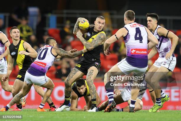 Dustin Martin of the Tigers controls the ball during the round 15 AFL match between the Richmond Tigers and the Fremantle Dockers at Metricon Stadium...