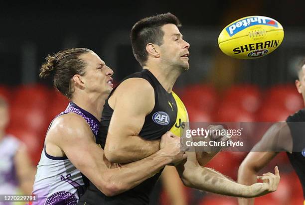 Trent Cotchin of the Tigers is challenged by Nat Fyfe of the Dockers during the round 15 AFL match between the Richmond Tigers and the Fremantle...