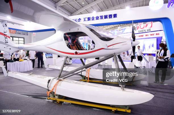 An electric airplane is on display at the stand of Liaoning Ruixiang General Aircraft Co., Ltd during the 19th China International Equipment...