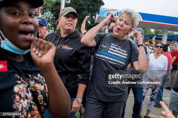 Supporters of the Black Lives Matter movement argue with Trump supporters on the day of President Trump's visit, September 1 in downtown Kenosha,...