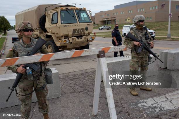 National Guardsmen guard a high school used as a staging areat on September 1 in Kenosha, Wisconsin. President Trump came to tour sections of the...