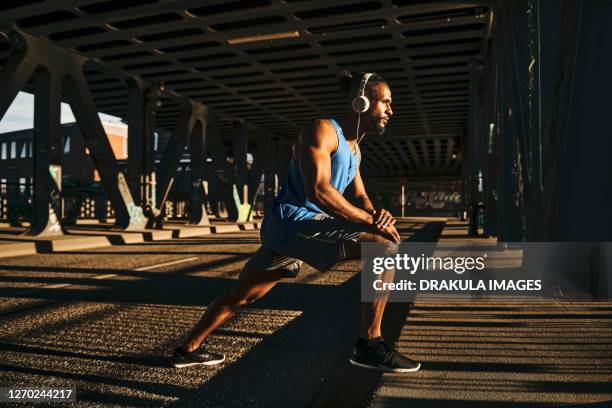 focused young athlete prepares for outdoor training - corrida de ponto imagens e fotografias de stock