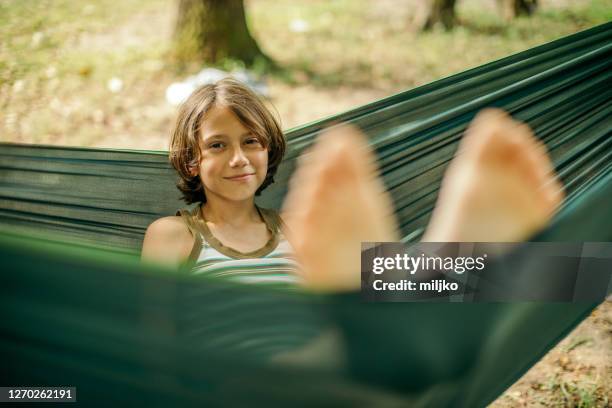 children relaxing in hammock - one teenage boy only stock pictures, royalty-free photos & images