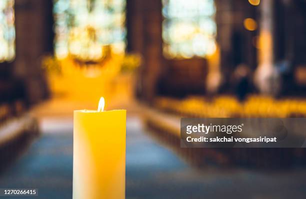 candle in the church - church interior stock pictures, royalty-free photos & images