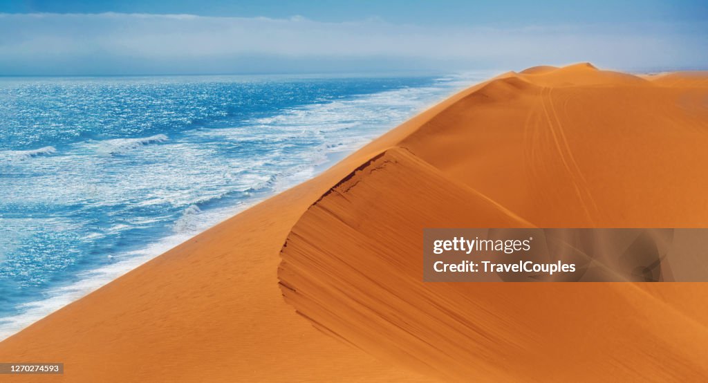 Sand Dunes and Ocean near Walvis Bay, Namibia. Coast of the atlantica ocean at the Namib-Naukluft national park, Namibia, south of Africa.