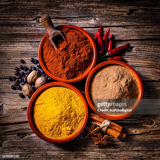 indian spices background: cinnamon powder, paprika and turmeric - clove stock pictures, royalty-free photos & images