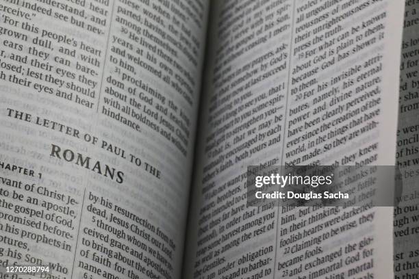 close-up of an opened holy bible - roman god stock-fotos und bilder