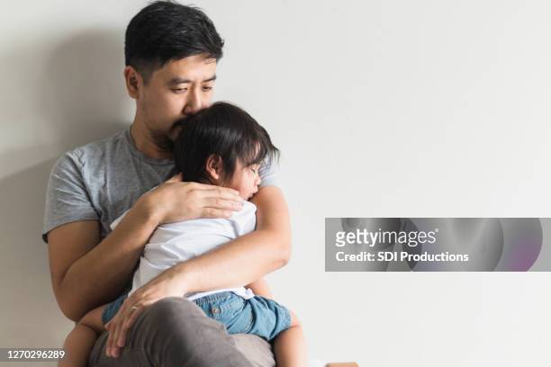 worried father comforts ill son - illness stock pictures, royalty-free photos & images