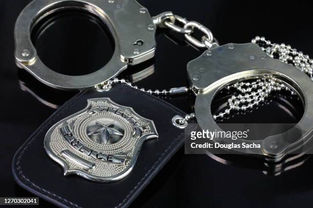 law enforcement badge and handcuffs - sheriff badge stock pictures, royalty-free photos & images