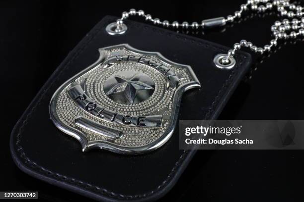 undercover police badge on black background - 警察官の制服 ストックフォトと画像