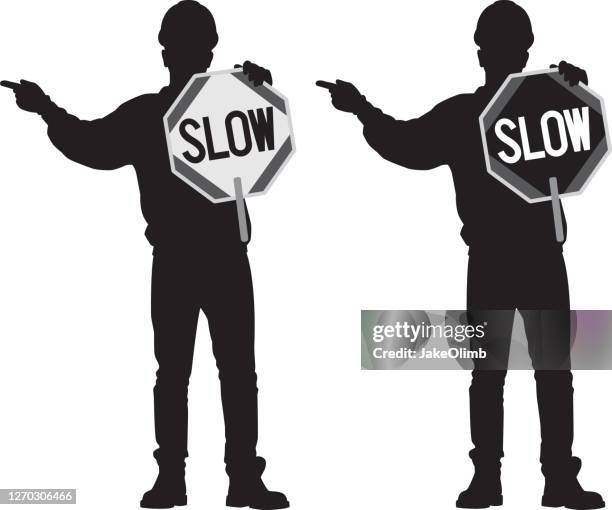 construction worker holding sign silhouette - roadworks stock illustrations