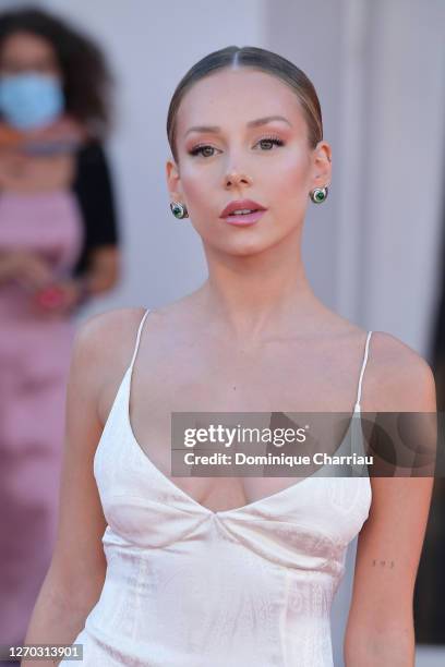 Ester Exposito walks the red carpet ahead of the Opening Ceremony and the "Lacci" red carpet during the 77th Venice Film Festival at on September 02,...