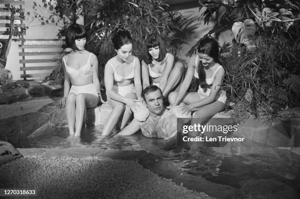 Scottish actor Sean Connery filming a bath scene for the James Bond film 'You Only Live Twice' at Pinewood Studios, UK, September 1966. His female...