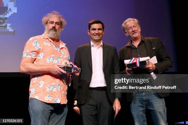 Mayor of Angouleme Xavier Bonnefont standing between Co-President of the Jury Benoit Delepine and Co-President of the Jury Gustave Kervern attend the...