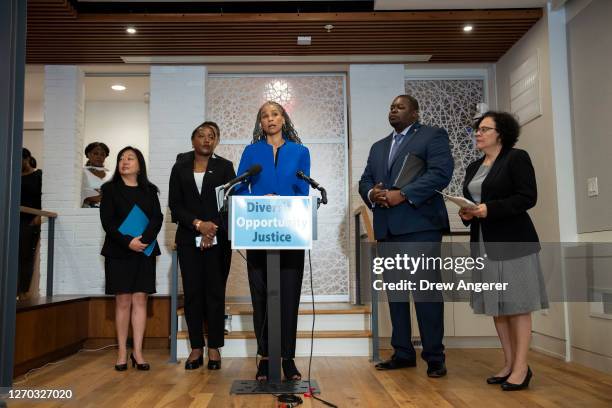 At center, Maya Wiley, President of the Leadership Conference on Civil and Human Rights, speaks during a news conference about the Supreme Court's...