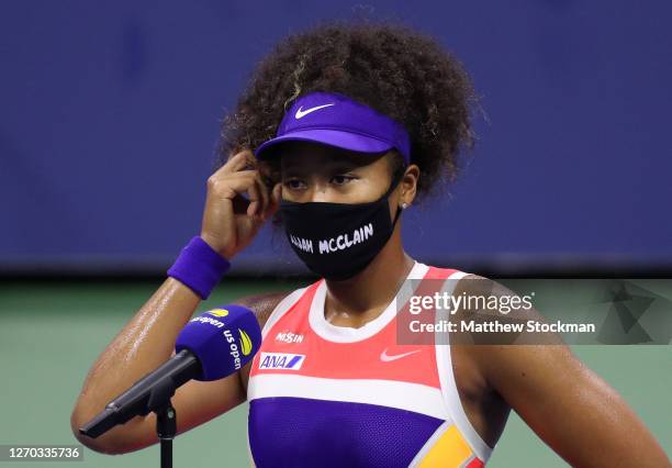 Naomi Osaka of Japan wears a mask with the name Elijah McClain on it following her Women’s Singles second round win against Camila Giorgi of Italy on...