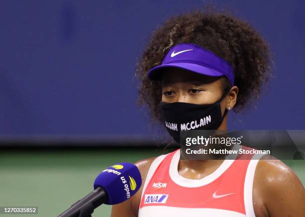 Naomi Osaka of Japan wears a mask with the name Elijah McClain on it following her Women’s Singles second round win against Camila Giorgi of Italy on...