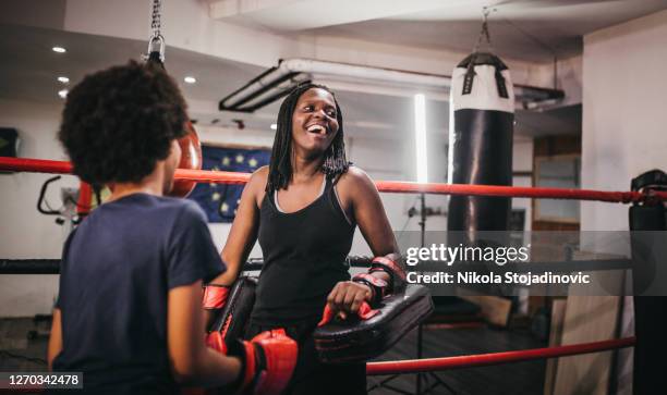 the mother teaches her daughter  boxing - boxing coach stock pictures, royalty-free photos & images