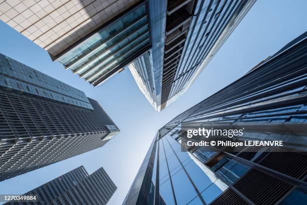 modern skyscrapers against blue sky low angle view - straßenschlucht stock-fotos und bilder