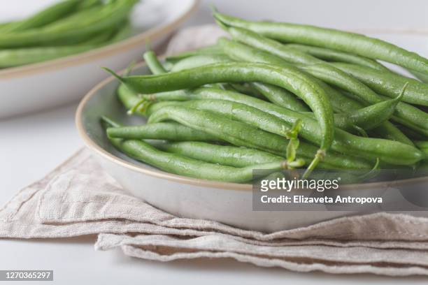 fresh green beans on a plate - bean stock pictures, royalty-free photos & images