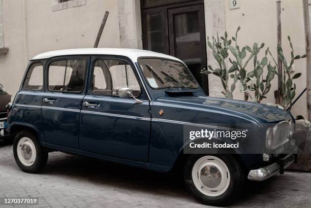 classic blue renault 4 parked. ortigia urban area. syracuse siracusa, sicily italy, summer season - old renault stock pictures, royalty-free photos & images