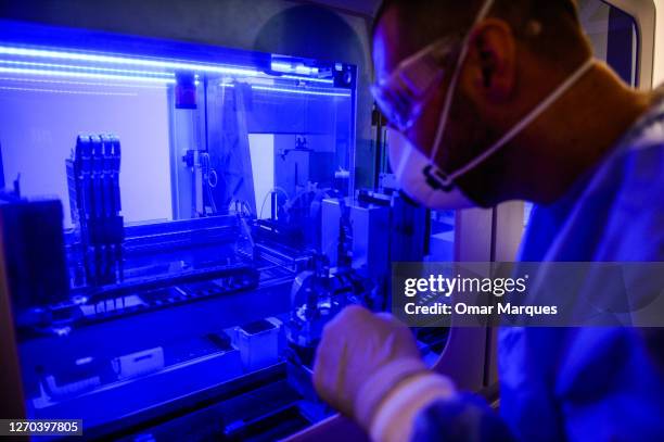 Krakow University Hospital Laboratory specialist inspects an automatized COVID 19 testing machine with swab samples on September 02, 2020 in Krakow,...