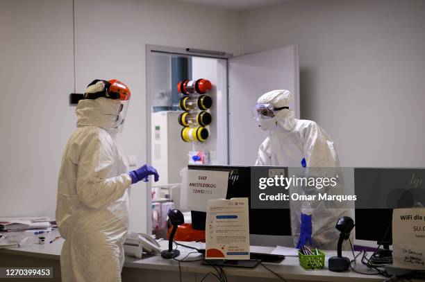 Medical personnel wear protective suits, masks, gloves and face shields during their shift inside the COVID 19 area at the Krakow University Hospital...
