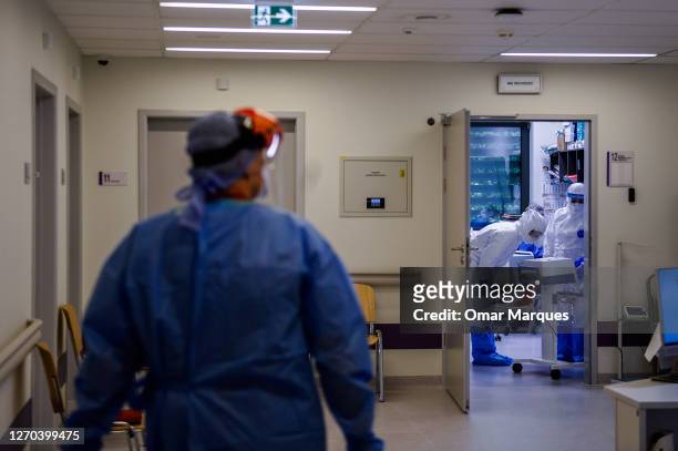 Medical personnel wear protective suits, masks, gloves and face shields during their shift inside the COVID 19 area at the Krakow University Hospital...