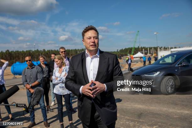 Tesla head Elon Musk talks to the press as he arrives to to have a look at the construction site of the new Tesla Gigafactory near Berlin on...