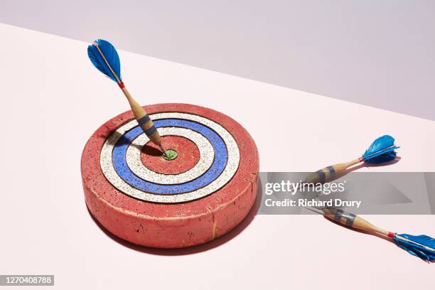 a dart in the bullseye of a dart board - darttavla bildbanksfoton och bilder