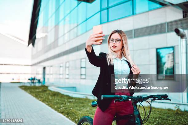 bicycle selfie by businesswoman outside - classic press conference stock pictures, royalty-free photos & images
