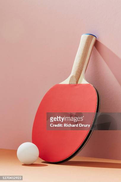 table tennis bat and ball leaning against a wall - table tennis bat stock pictures, royalty-free photos & images